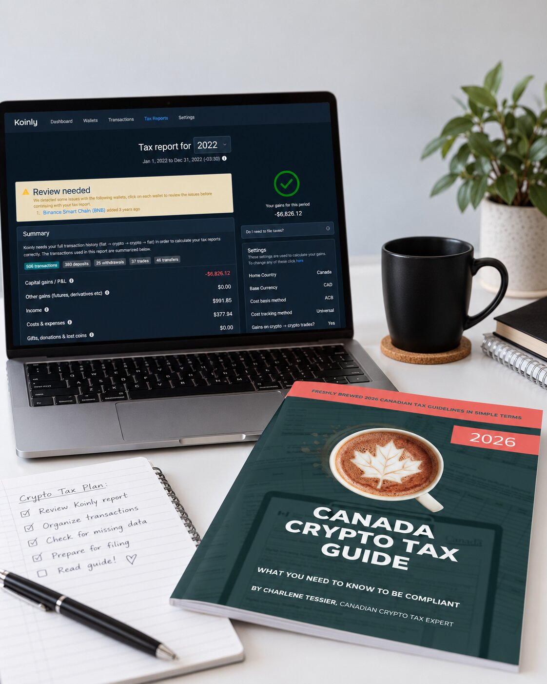 A laptop showing a Koinly tax report next to the Canada Crypto Tax Guide, a coffee mug and a handwritten crypto tax plan